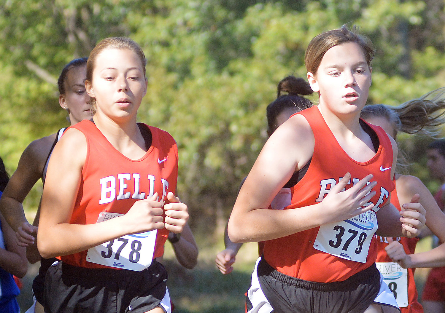 Natalie Gehlert and Tajel McDaniel (from left) set the early pace for Belle in the varsity girls race at Friday’s GVC meet in Steelville.